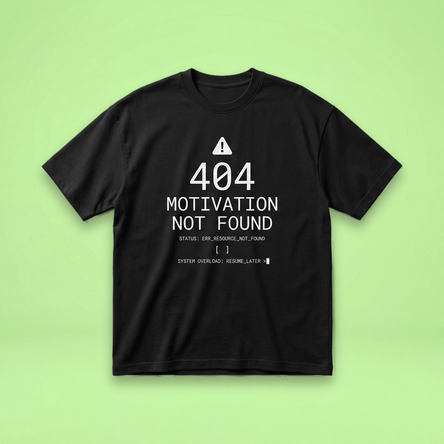 Black t-shirt on a light green background with the text "404 MOTIVATION NOT FOUND" and a computer error-style message printed in white on the front.